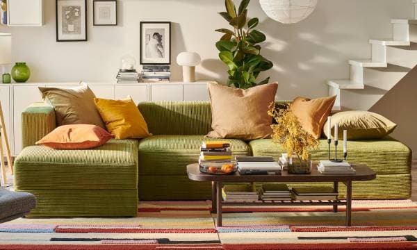 JÄTTEBO green sofa with earthy colour cushions in the living room