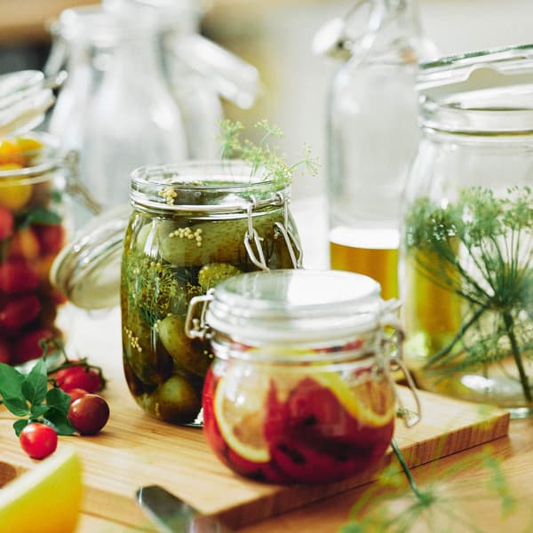 Jars of IKEA pickles, lemons and more on a tabletop.