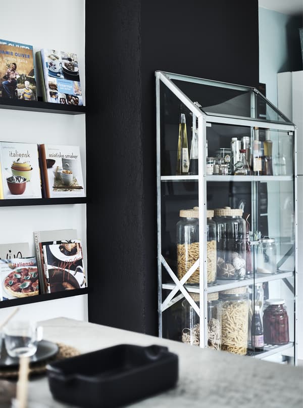 Jars of ingredients in a glass cabinet.