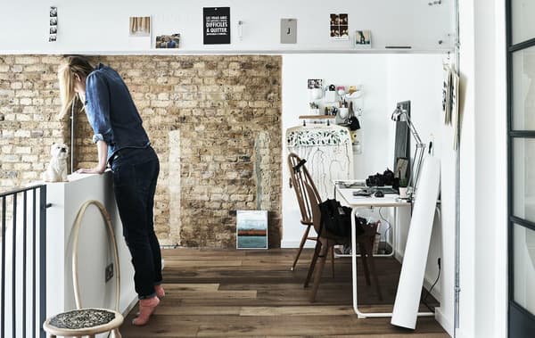 Jules looking over the staircase, next to her work area.