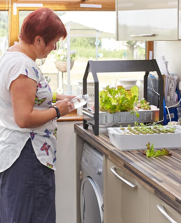 Juliette in her kitchen planting
