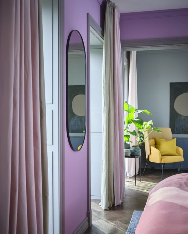 KALKFLY light pink curtains and KALKFLY dark beige room darkening curtains hang by large windows and cover half of them.