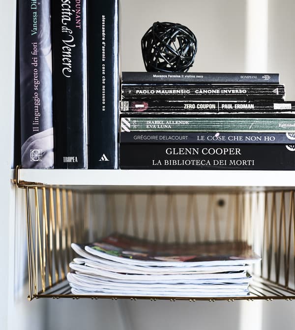 KALLAX alcove with basket inserts and books inside.