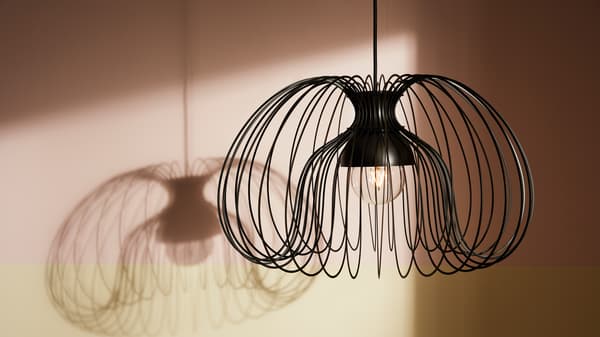 KALLFRONT metal pendant lampshade hangs from the ceiling creating a dramatic shadow in the background.