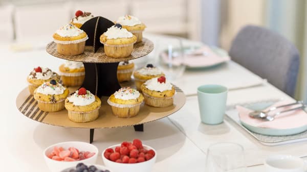Karton Etagere mit MUffins auf einem Esstisch