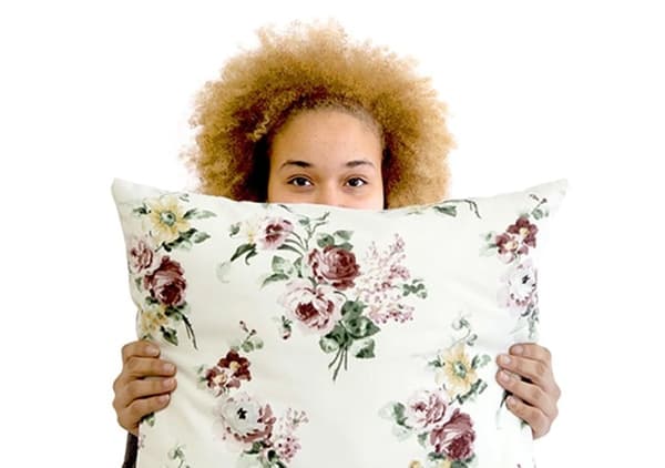 Kathy from Ellas lo Bordan holding a cushion from the ÅTERSTÄLLA collection