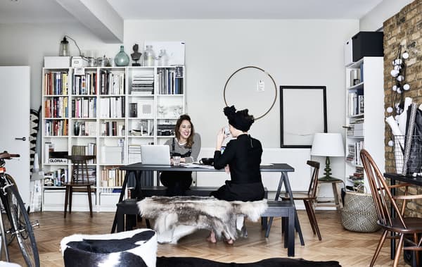Katie and Elkie working at a table and an open storage unit.