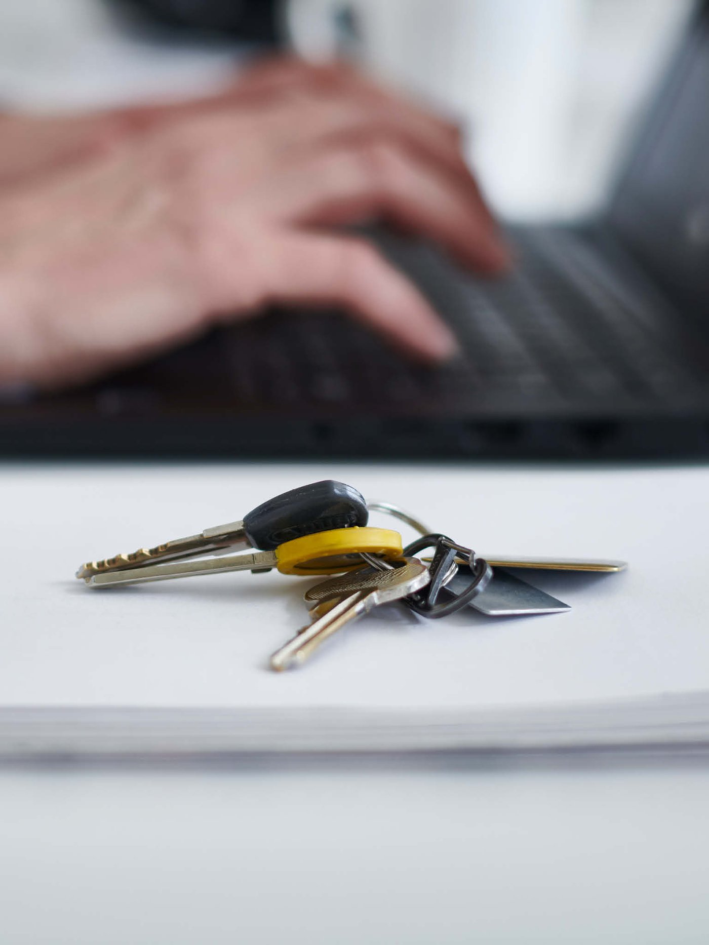 Keys next to a laptop