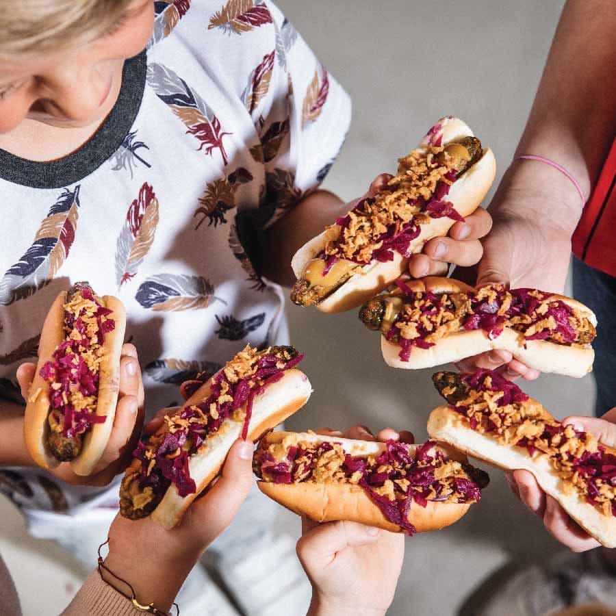 Kids holding IKEA bistro's hotdogs