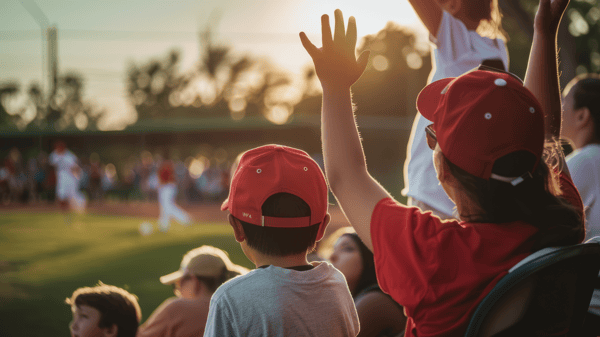 Kids in stadium seats watching a baseball game