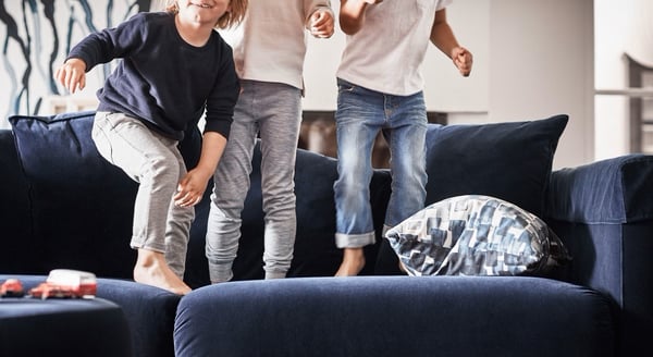 Kids jumping on a sofa