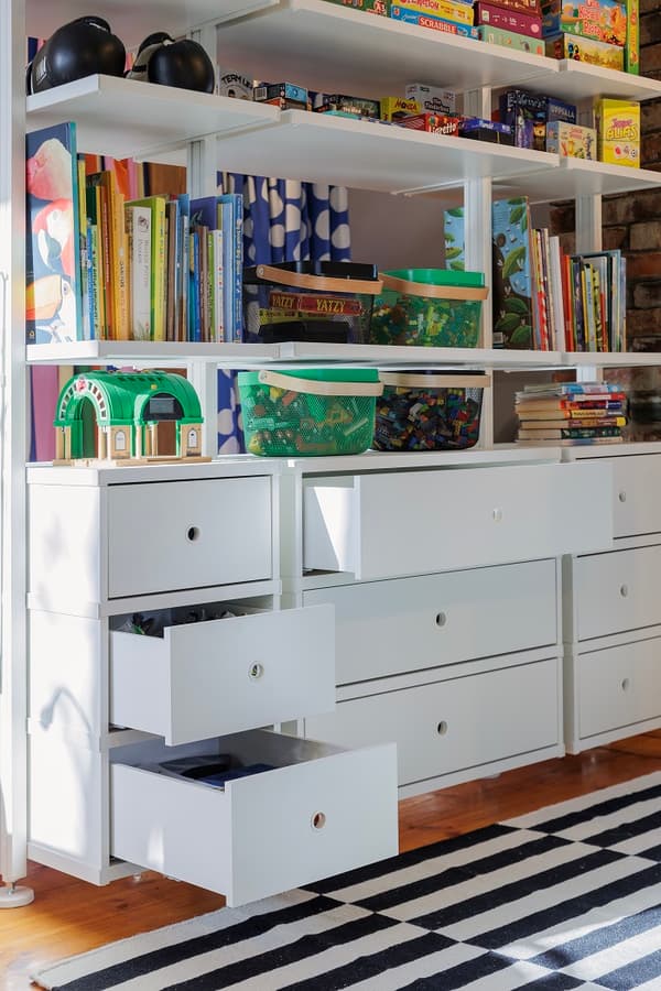 Kids storage drawers with toys and organized shelves close up