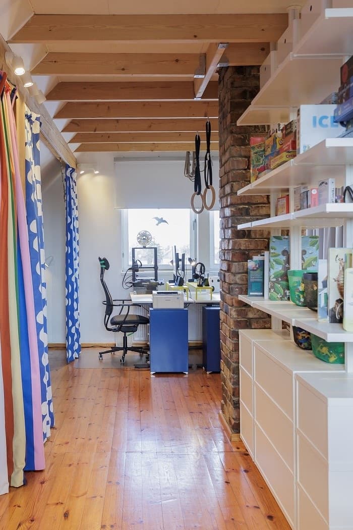 Kids workspace with desk, computer setup and storage in attic room