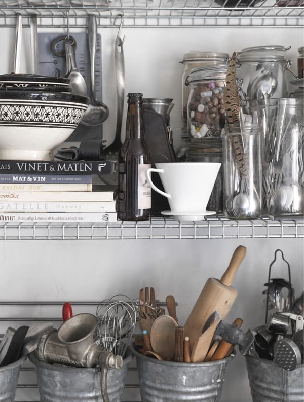 Kitchen accessories stored in jars and buckets.