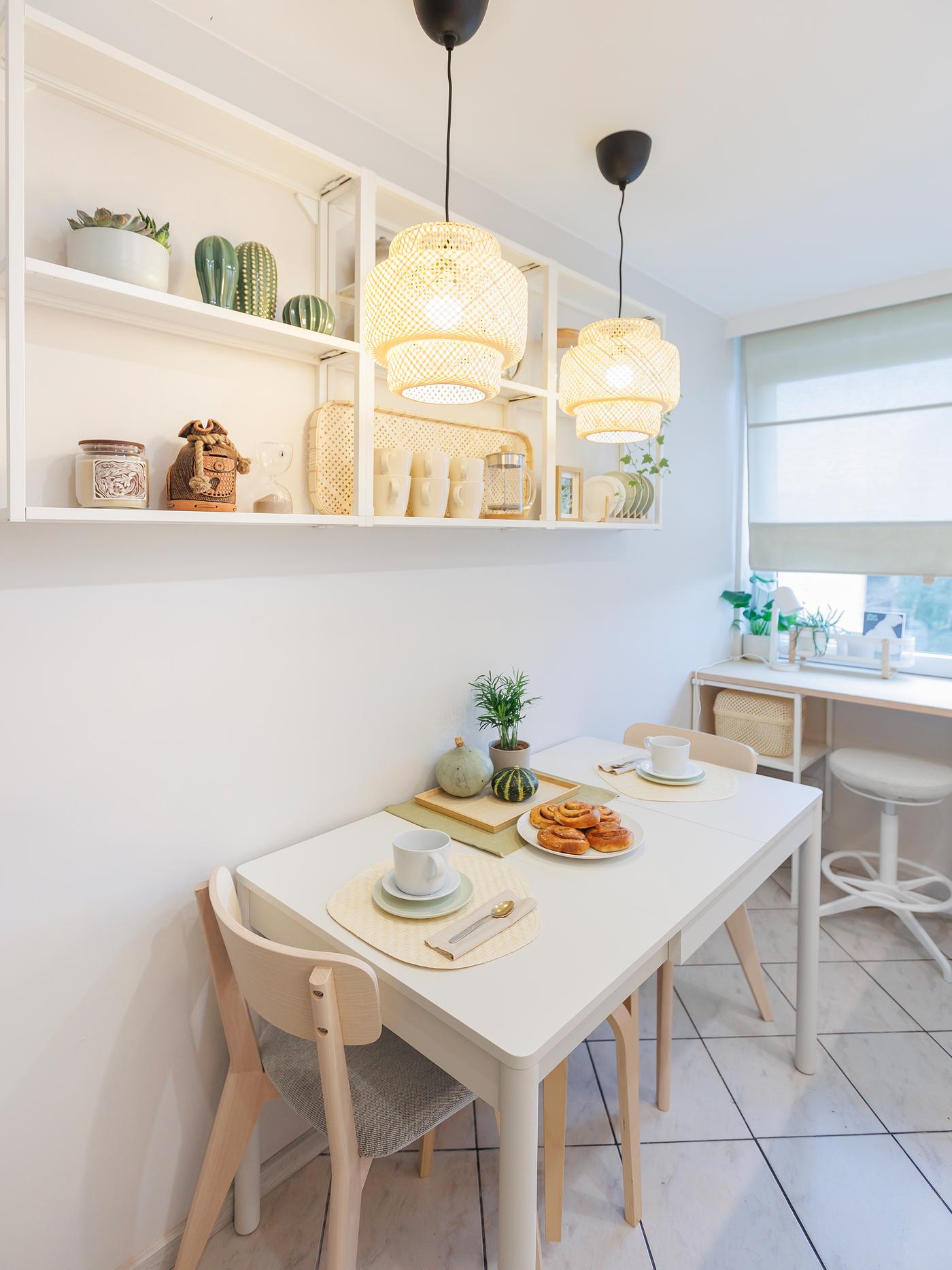 Kitchen corner with a dining table, two chairs, and two handmade pendant lamps hanging above the table.
