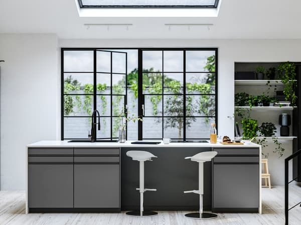 Kitchen with VOXTRORP doors in dark grey matte finish and white worktops in front of black french doors 