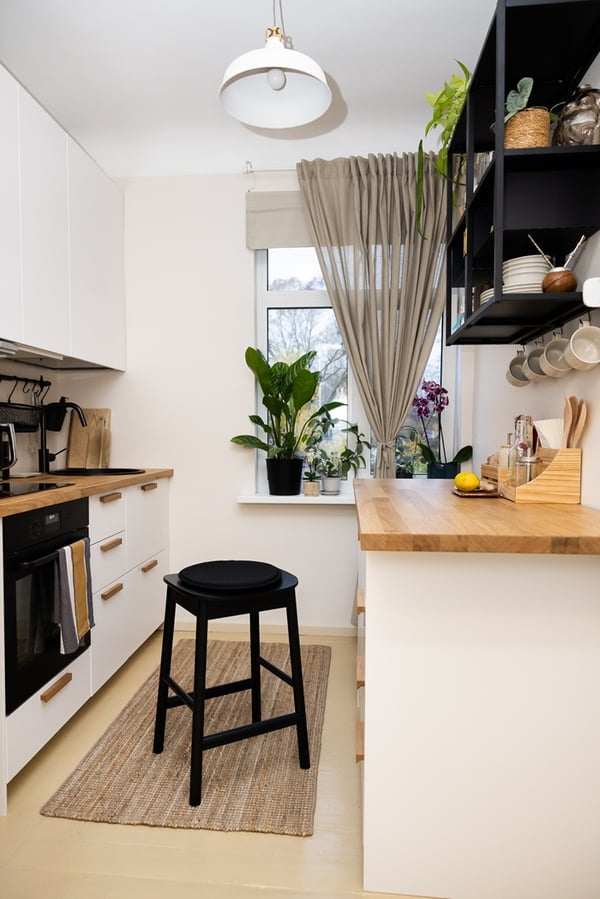 Kitchen work area with drawers under the worktop and a wall shelf for everyday items.