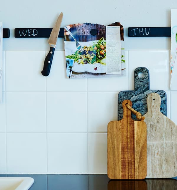 Knife rack painted with chalkboard paint hold knives and recipes.