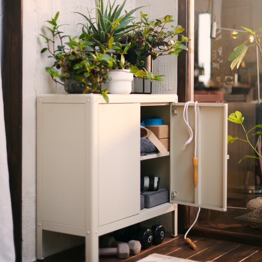 KOLBJÖRN outdoor approved storage system with storage for shoes and plants on top.