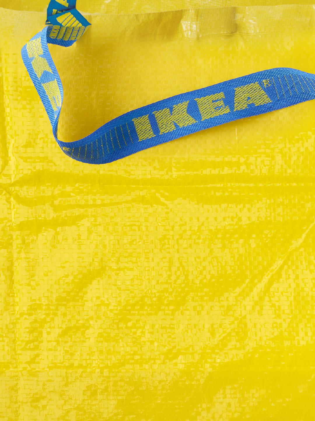 Krupni plan žute IKEA plastične vrećice s plavom ručkom na kojoj je ispisan natpis "IKEA".