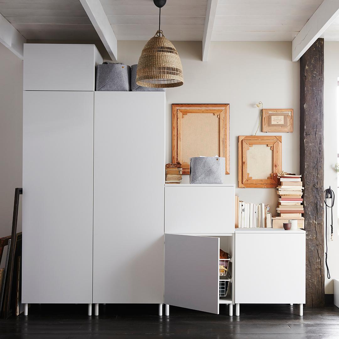 Különböző magasságú fehér szekrények, lépcsőhatást keltve. Az alacsonytól egészen a mennyezetig érőig.