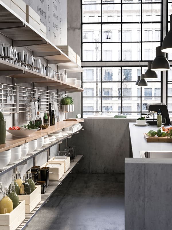 KUNGSFORS suspension shelf behind a café counter with a coffee machine. Open shelves hold coffee pots, bowls, and food.