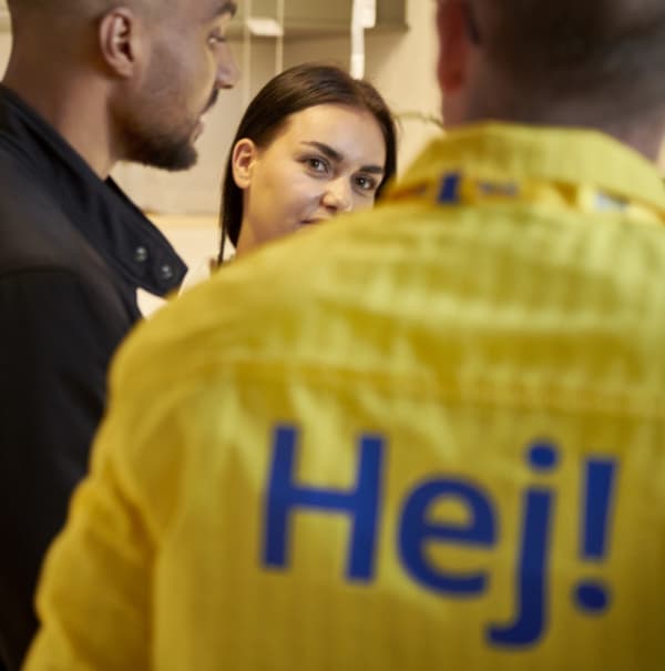 Kupca se pogovarjata z zaposlenim v podjetju IKEA.