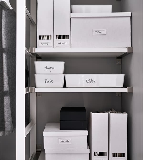 Labeled boxes and magazine holders keep things organised on a shelf.