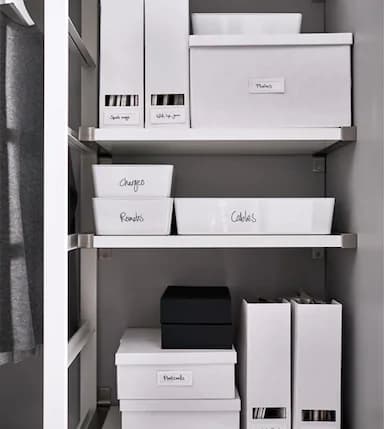 Labeled boxes and magazine holders keep things organised on a shelf.
