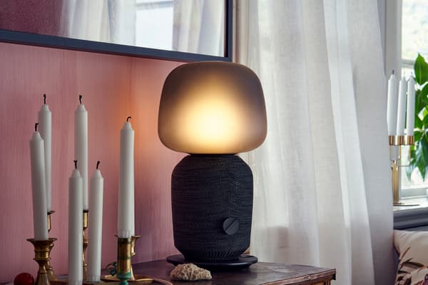 Lampa s reproduktorem SYMFONISK  na stolku 