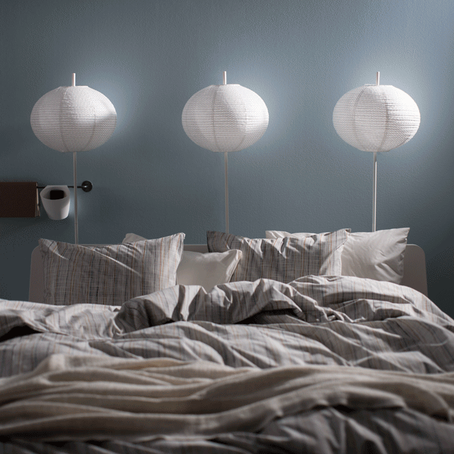 Lamps above a bed turning on in sequence.