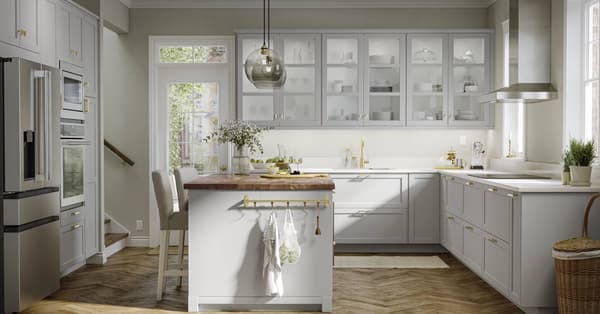 LERHYTTAN light gray kitchen with a kitchen island with wood countertops.