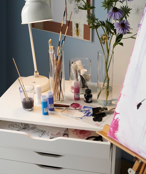 Let a storage unit that blends in with the rest of your space double as both a place to store paintings and a charging station for your gadgets! Try IKEA ALEX white drawer unit on castors!