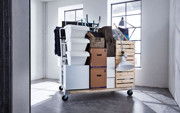 Link to '7 tips for moving homes' - image of various moving supplies on a pallet with wheels.
