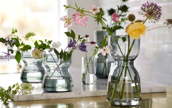 Link to 'A collection that offers comfort for every body' - image of glass vases filled with flowers.