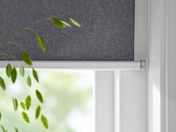 Link to 'Getting started and how to use smart blinds' - close-up view of a FYRTUR smart window blind with houseplant in foreground.