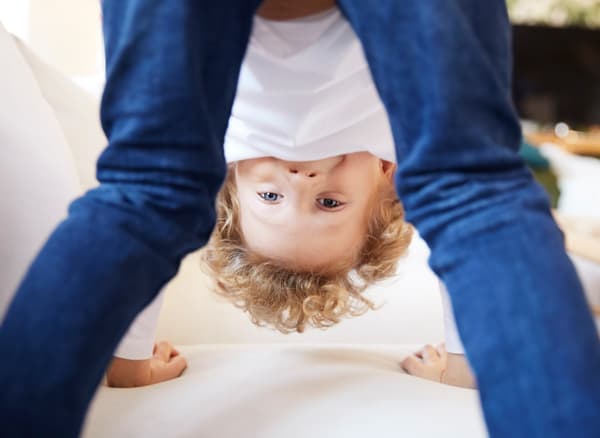 Link to 'How IKEA develops safe products' - image of a boy standing on all fours while playing.