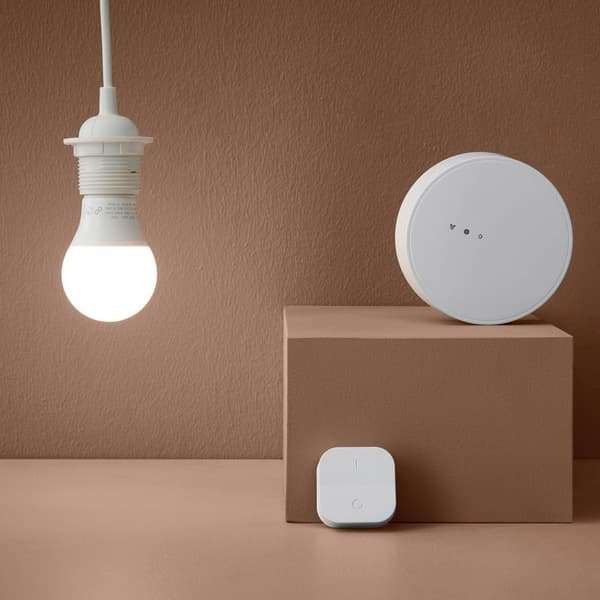 Lit lightbulb next to IKEA smart controls​.