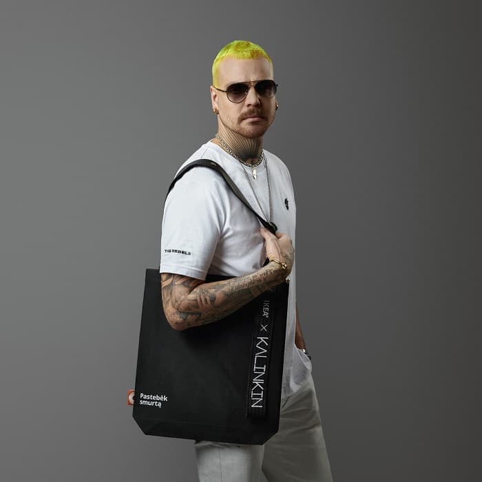 Lithuanian fashion designer Robert Kalinkin wearing a limited “Notice violence” bag. 