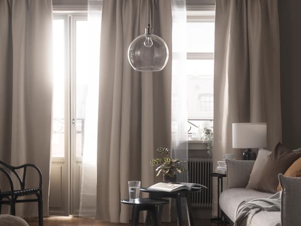 Living room setting with beige VILBORG room darkening curtains.
