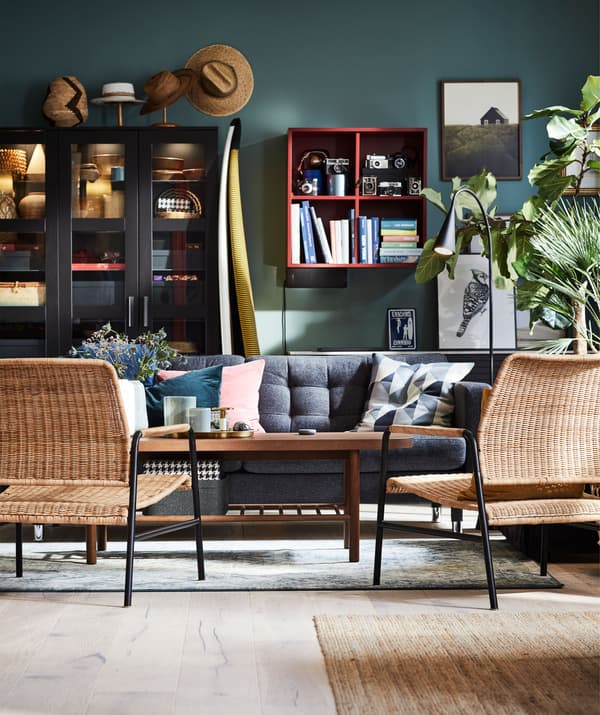 Living room with rattan ULRIKSBERG seating and MORABO sofa around a coffee table, against a wall with multiple storage options.