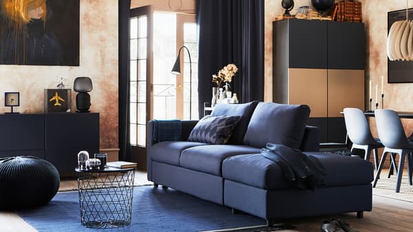 Living room with VIMLE 3-seat sofa bed and ORRSTA black-blue cover, various cabinets, some seating and open patio doors.