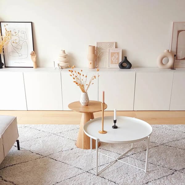 livingroom space with bright colors. There are tables in the front and a large cabinet in the back