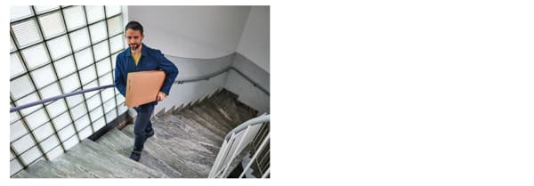 livreur qui monte un colis au domicile du client