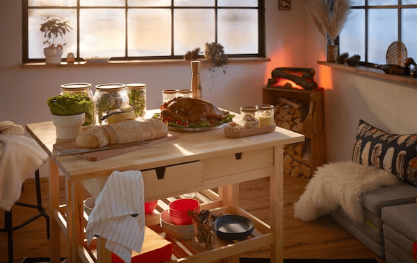 Log-cabin style interior with a small but festive buffet set on double kitchen trolleys; fake fireplace in the corner.