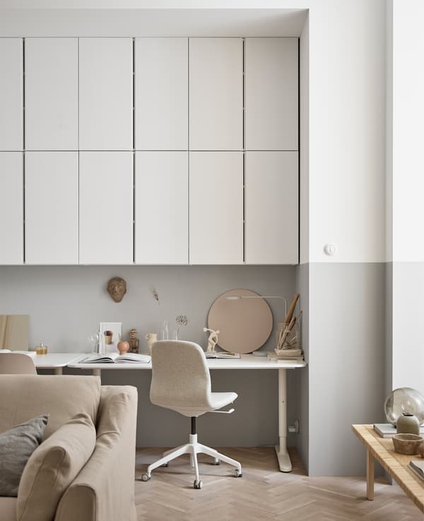 Lots of overhead wall cabinets create lots of storage space for a workspace in the living room.