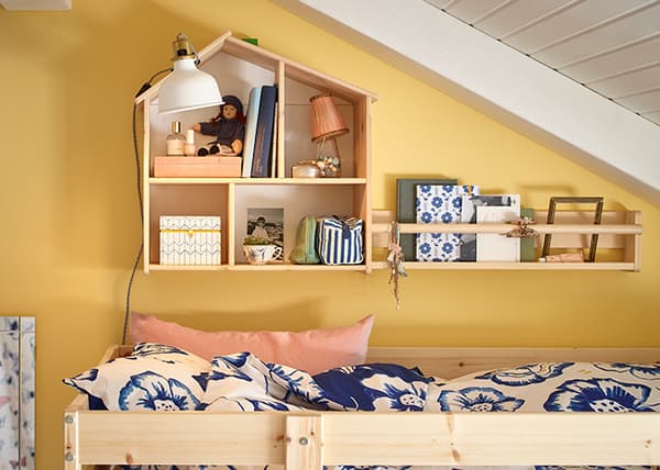 Maison de poupée montée au mur au-dessus de lits superposés dans une chambre d'enfant