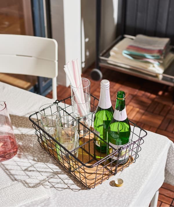 Make serving refreshments a breeze with IKEA PLEJA wire basket with handle in black steel and cork!