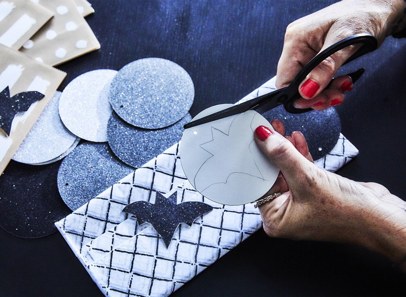 Make your own holiday Halloween treats! Just cut out some bats to glue on a couple of paper candy bags and fill them  (we used IKEA WINTER gift tags) with something sweet.