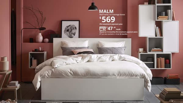 MALM queen-sized bedframe with 4 storage  boxes in a scandinavian bedroom. Words on image say Lower prices, MALM bedframe, w 4 storage boxes $569. 0% instalment payment plan $47.41 per month. Based on 12-monthly 0% instalment payment plan. IPP are also available in 6 or 24 months. 